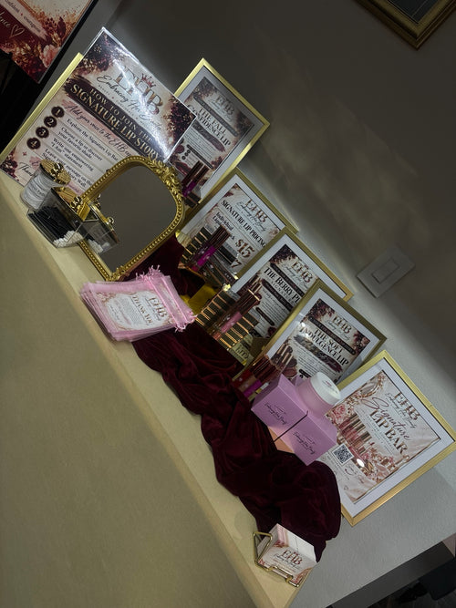 Embracing Her Beauty Signature Lip Bar display with lip products and gold framed signs