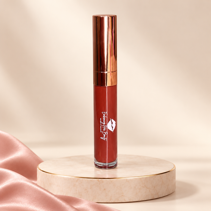 Indulge liquid lipstick in its original rose-gold tube on an ivory pedestal with blush satin