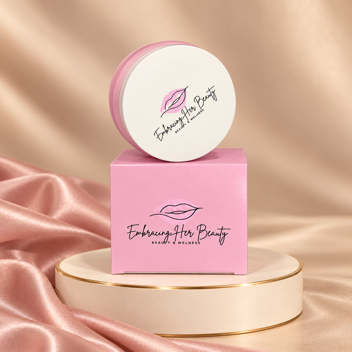 Makeup Be Gone Cleansing Balm in its original pink packaging on an ivory pedestal with gold trim and blush satin