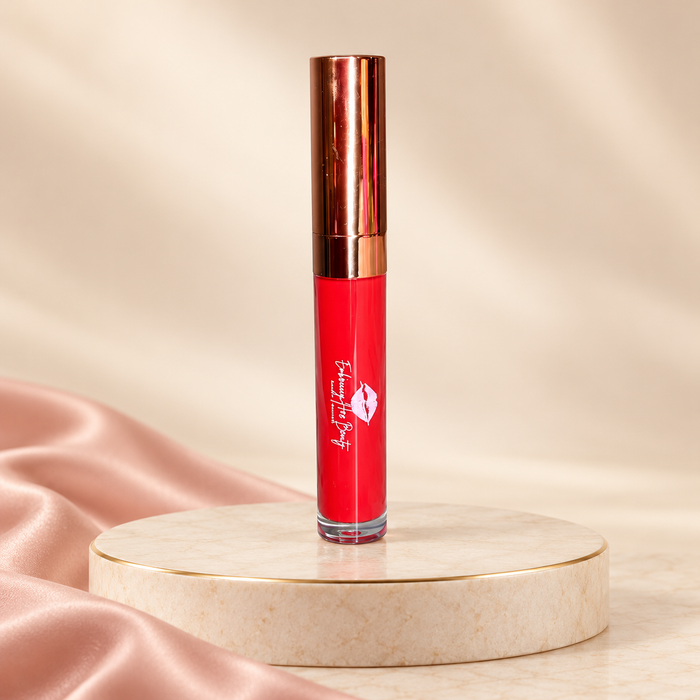 Savage liquid lipstick in its original rose-gold tube on an ivory pedestal with blush satin